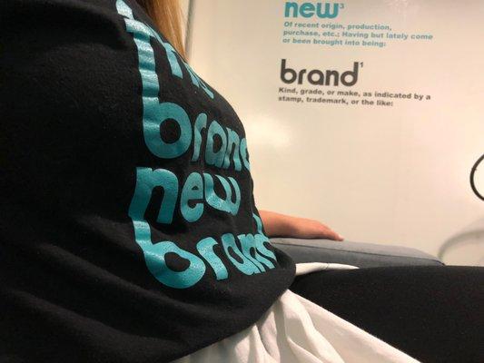 The Brand New Brand Team Member showing off her stylish tee shirt.