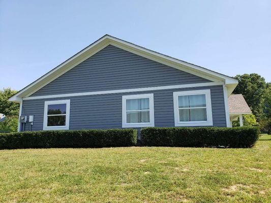 Vinyl siding and soffit, 5.25in wood trim around windows and to divide the gable end.