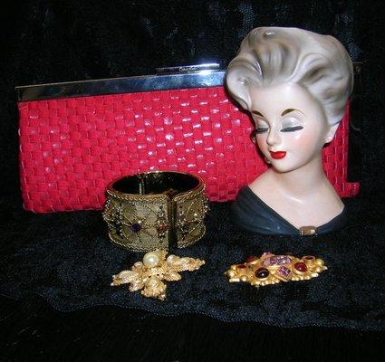 Red clutch purse and antique jewelry.