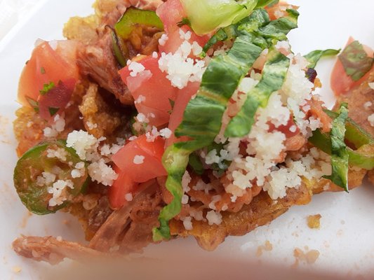 Tostones with pulled pork and pico's. Yummy