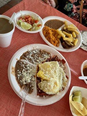 The chilaquiles rojos with egg on the bottom and plate on top is milanesa con papa.