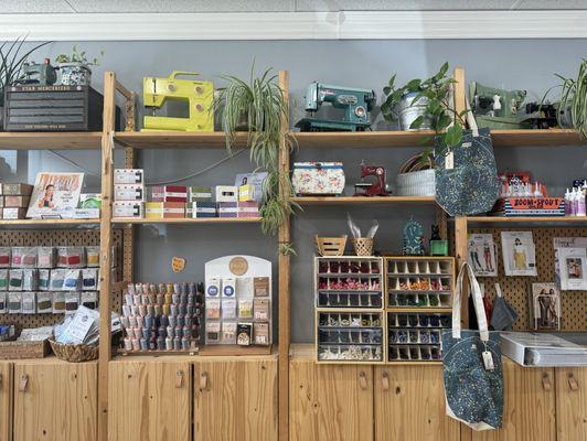 Beautiful shelves of threads and sewing items.