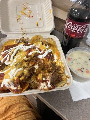 Loaded nachos, soup, and a coke.