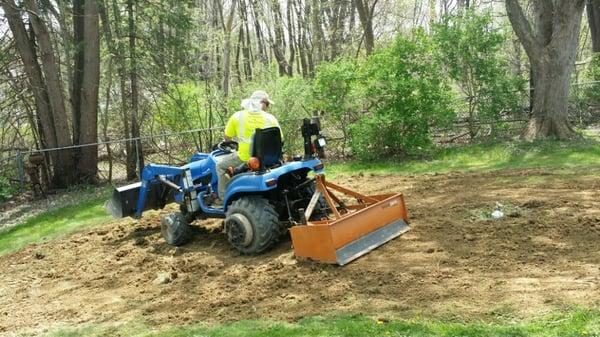 Grading an area in preparation for putting in a new lawn.