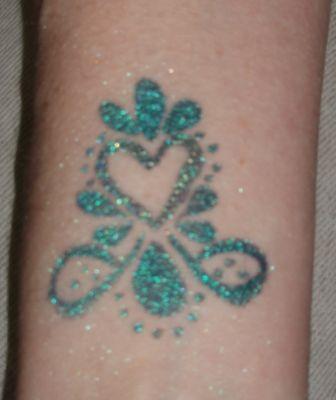 Hand painted "mica tat" similar to glitter tats without the mess. Special paint and mica pwd lasts 3-7. Removes easily if needed.