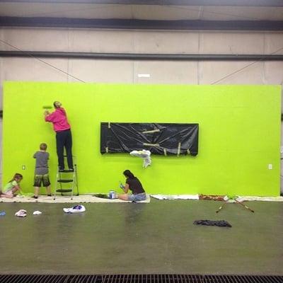 Coach Allie and her little helpers painting out the information wall with WODIFY TVs installed!