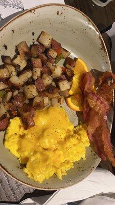 Scrambled eggs with cheese, bacon and delicious potatoes