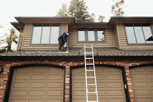 Johnny applying our industrial grade moss killing powder to the roof