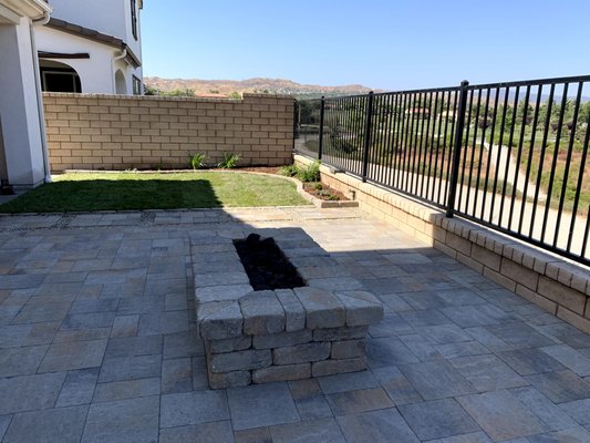 Firepit with custom cut corners, interior drain for rain water, and volcano rocks.  Gas line connected to meter for full power!