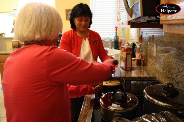 Our caregiver assisting a client with a home cooked meal.