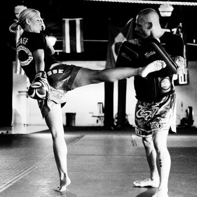 Coach Danika cracking the Muay Thai pads with a great roundhouse kick, Daddis Mixed Martial Arts Academy Cherry Hill NJ