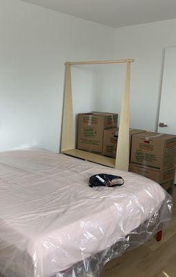 Queen bed, coat rack, boxes