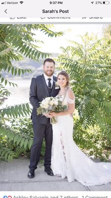 The bridal bouquet also done by Tom's Greenhouse made of white peonies dahlias silver dollar eucalyptus dusty miller and lavender roses