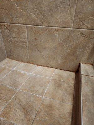 Gaps in grout & unsightly rust orange color a year later.