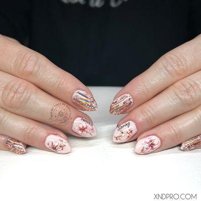 Cute little stiletto nails with watercolor style flowers. Ready for spring