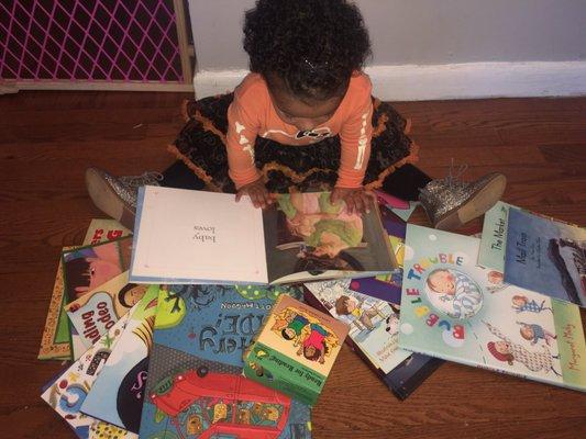 Alyee loves her books VT gave her!