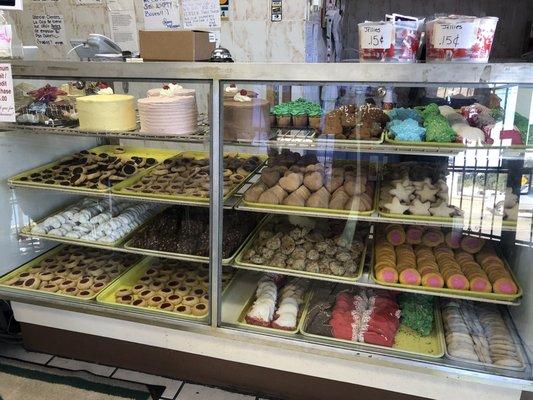 Bakery display case with a variety of cakes & cookies.