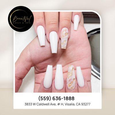 Sophisticated white nails with marble details and gold touches--perfect for a chic and refined look