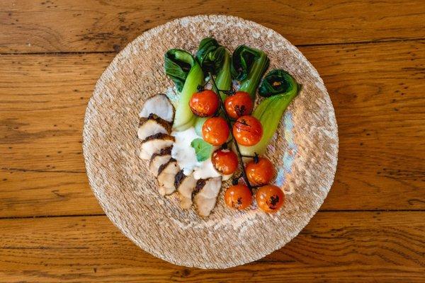 Blackened monkfish dressed in a horseradish sauce with a side of bok choy.