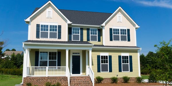 Newly constructed home siding, windows, shutters and gutters.