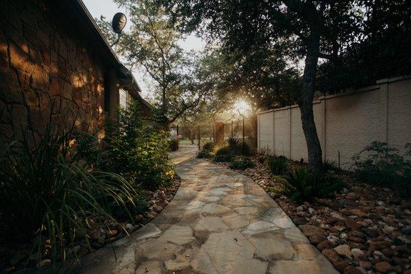 Sides of the house are unusable for anything. The walkway and landscape is the perfect solution.