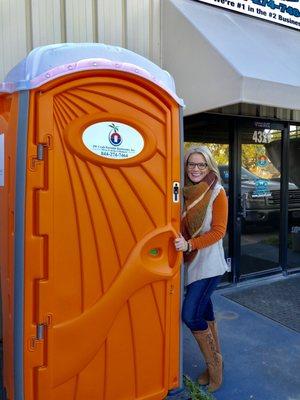 VP and co-owner Jennifer Corrigan with Aspen standard size porta potty.