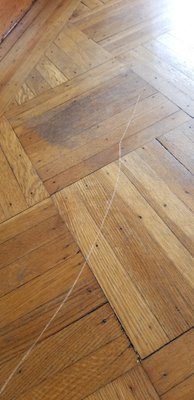 Huge, deep scratch put in floor of the house I was moving out of. Told to cover it with crayon.