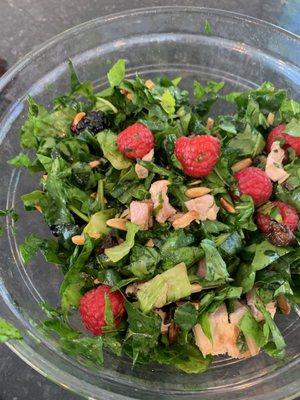 Fresh spinach, arugula and berry salad with diced chicken.