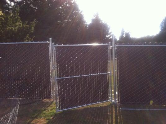 An almost finished chain link privacy fence