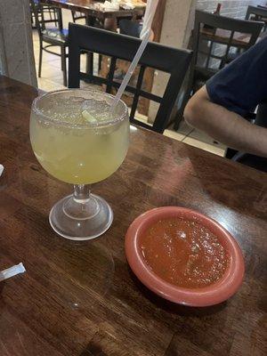 Medium regular margarita next to their salsa