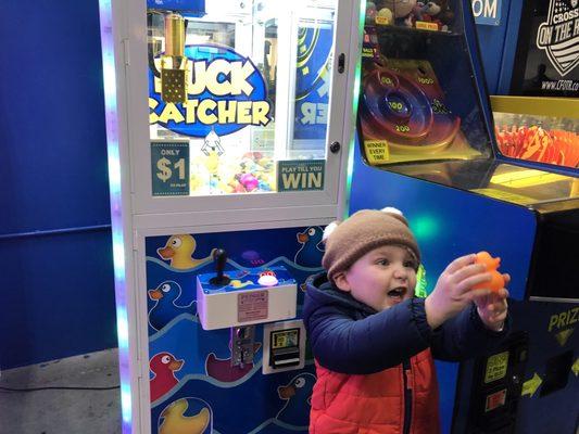 Maverick was so excited to win a rubber ducky on the claw machine!