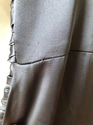 Damage to fabric, poorly sewn seam