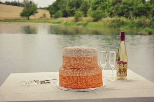 Two-tiered, ombre-ruffle wedding cake.