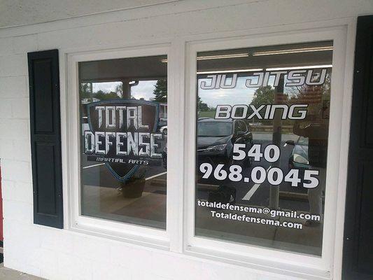 The front windows of Total Defense Martial Arts.