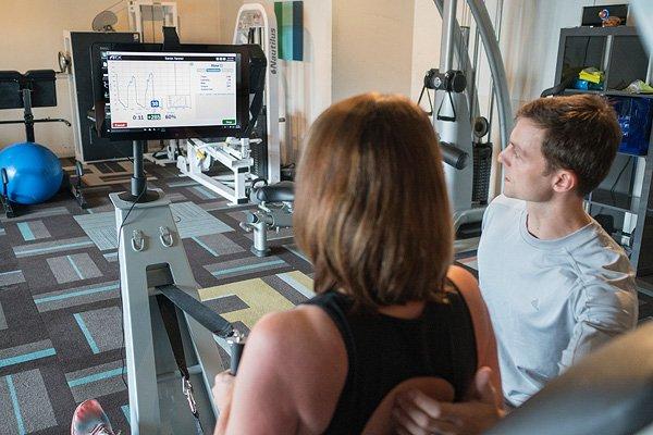 Founders, Sarah and Skyler Tanner operating training equipment in their new Smart Strength training facility in Westlake.