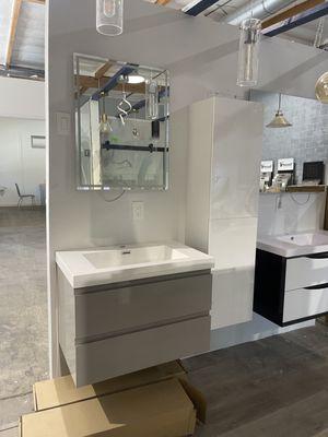 A 24x30 LED mirror with a 30" light grey wall  vanity