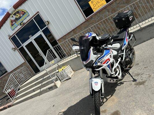 That's a nice bike! Front of restaurant. Motorcycle rider and group friendly. Miles of smiles. Can gas up next door.