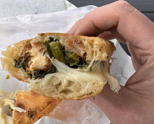 Hot, fresh bread, freshly cooked chicken cutlet, broccoli rabe, provolone and garlic. Yummy!  Pic doesn't do it justice