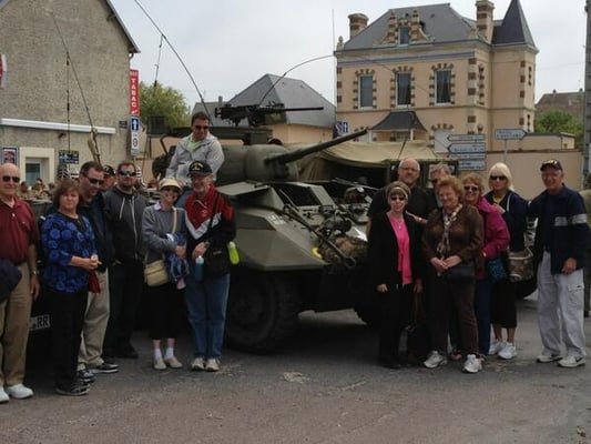 Our group posing by a 6-wheel reconnaissance vehicle still running on Utah Beach today.