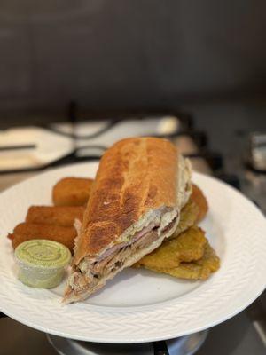 Cuban sandwich, ham croquettes, papa rellenas, and tostones.