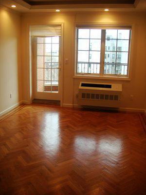 Bright, sunny living room with hardwood floors.