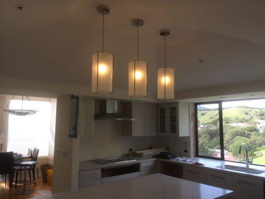 Custom frosted cylinder pendants with polished nickel hardware for this Tiburon residence.