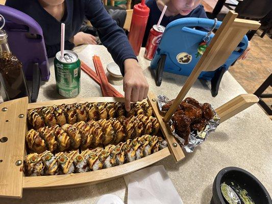 Sushi boat with Two fried rolls and mango habanero wings