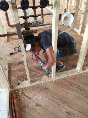 Oldest son working hard drilling through 150 yr old floors :)