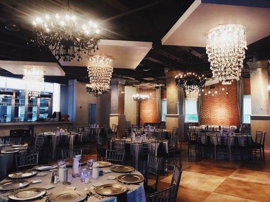 Stunning space! Love the chandeliers and exposed brick.