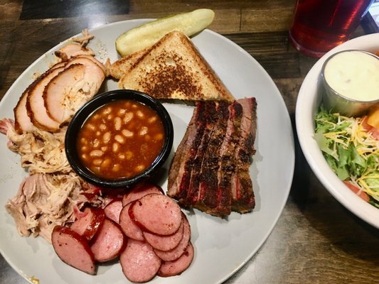 4 Meat combo with smoky baked beans, pickle and Texas toast. Moist and delicious.