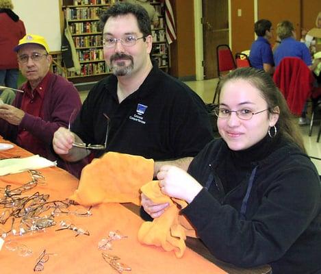 Erik Johnson and Kassandra Garcia cleaning eyeglasses to help support the Tucson Downtown Lions Club.