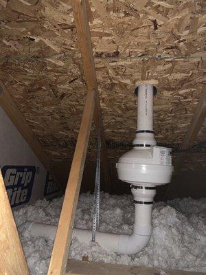 Mitigation pipe in attic with fan, exiting up thru the roof of garage.