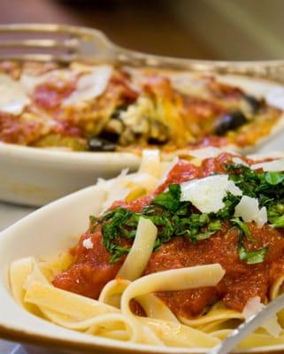 Eggplant Involtini (background) with a side of pasta