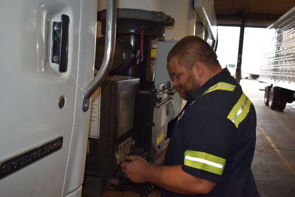 Brandon repairing a customer's vacum truck.